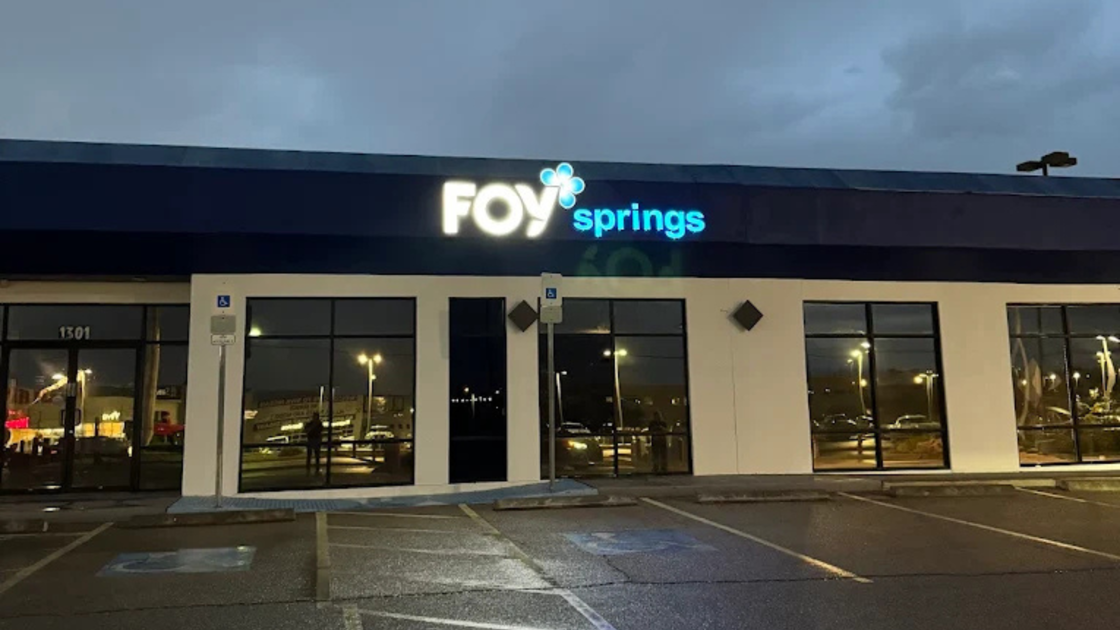 Foy Water storefront at dusk